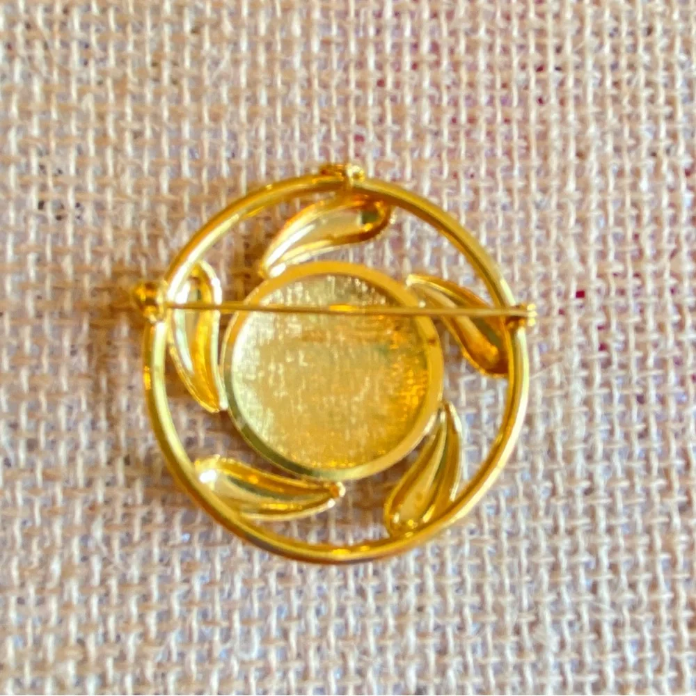 Convertible brooch and pendant circle with red enamel center in goldtone metal